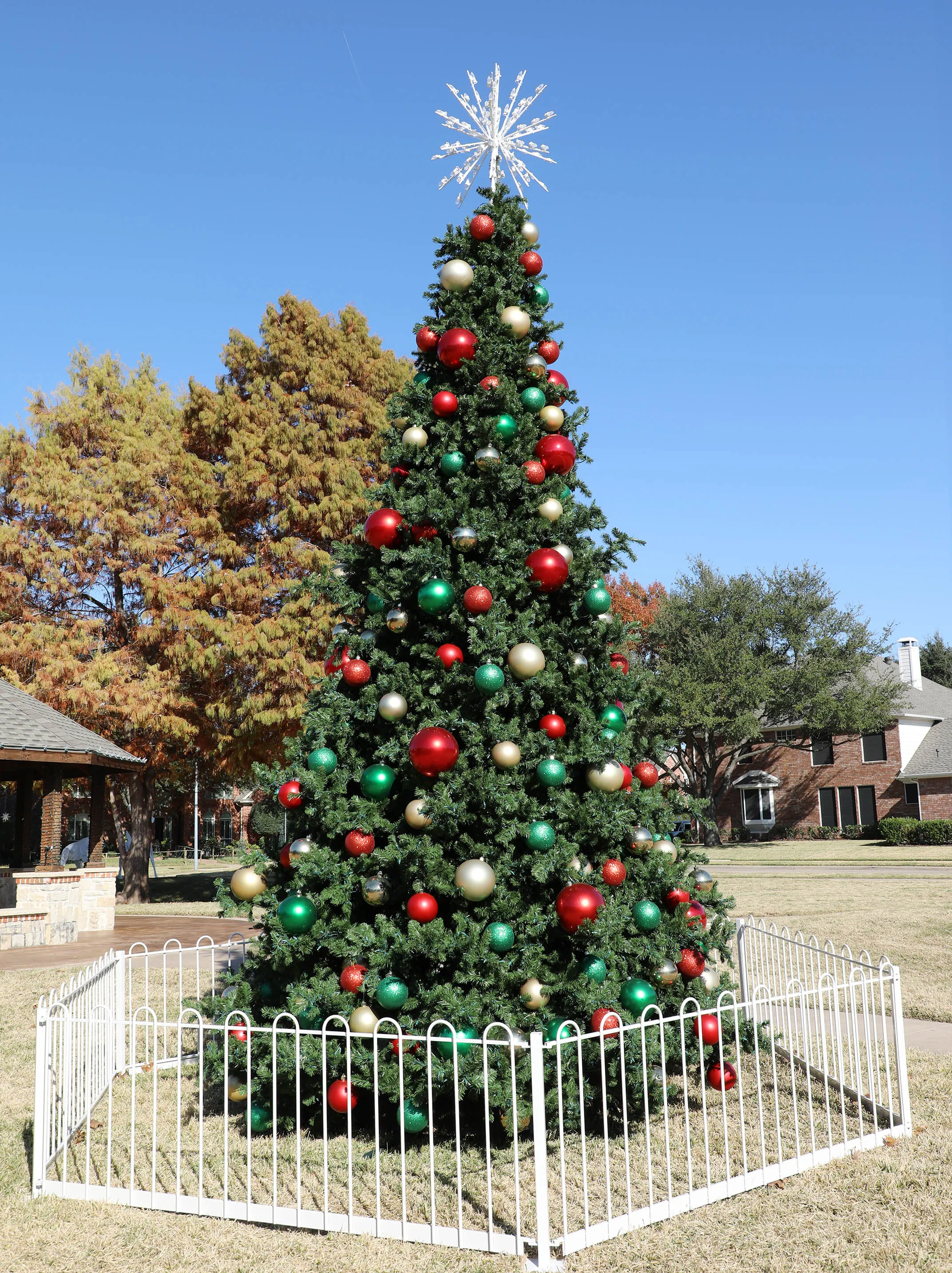 Decorated outdoor Christmas tree with ornaments and lights