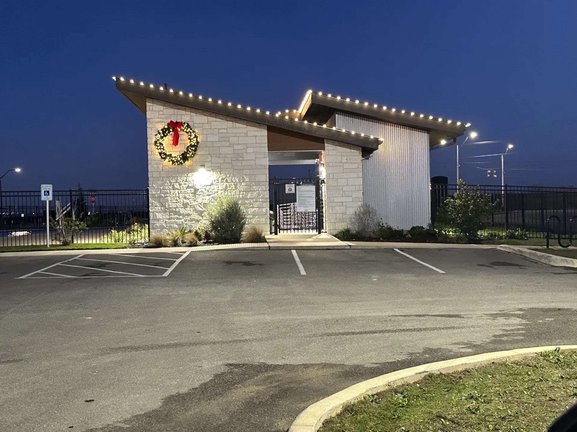 Roofline holiday lighting with a lit wreath